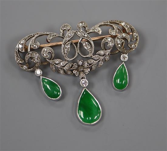 A 1920s yellow metal, diamond and jadeite set drop openwork scroll brooch, width 38mm.